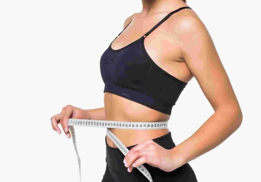 young-fitness-woman-measure-with-tape-her-belly-isolated-white-wall (1)
