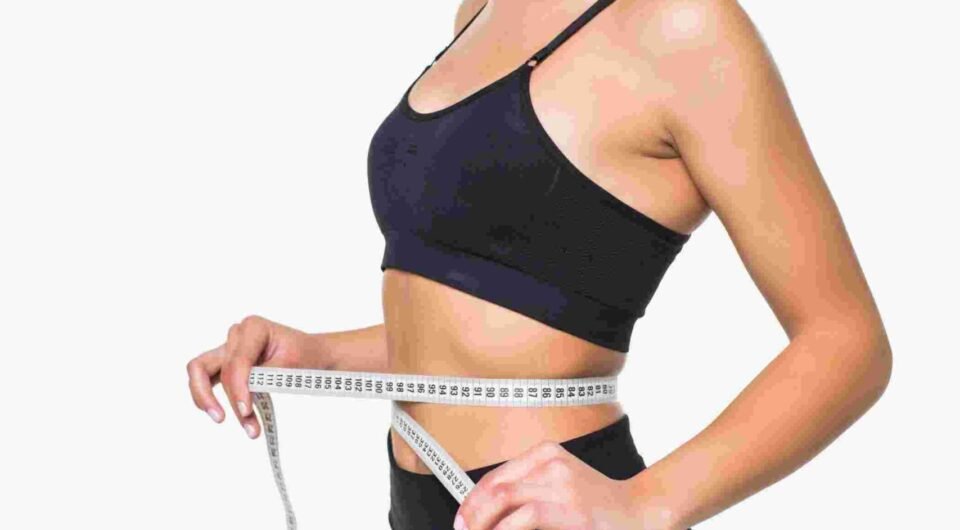 young-fitness-woman-measure-with-tape-her-belly-isolated-white-wall (1)